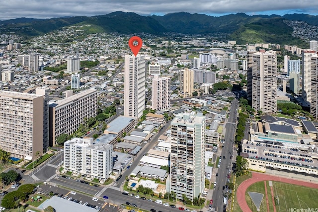 555 University Ave Unit 100, Honolulu, HI 96826 - aerial overview of property's location featuring a mountainous background and nearby urban area
