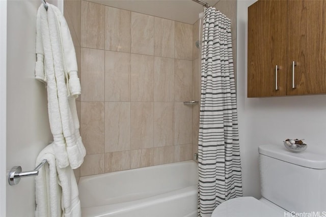 bathroom with shower / bath combo with shower curtain and toilet