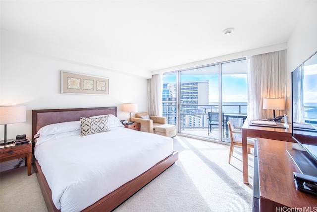 carpeted bedroom featuring access to outside and a wall of windows