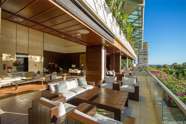 view of patio with an outdoor living space and a balcony