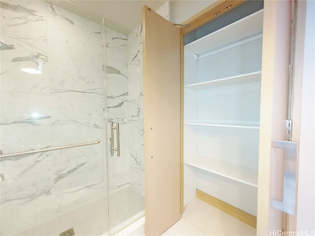 bathroom featuring an enclosed shower and tile patterned floors