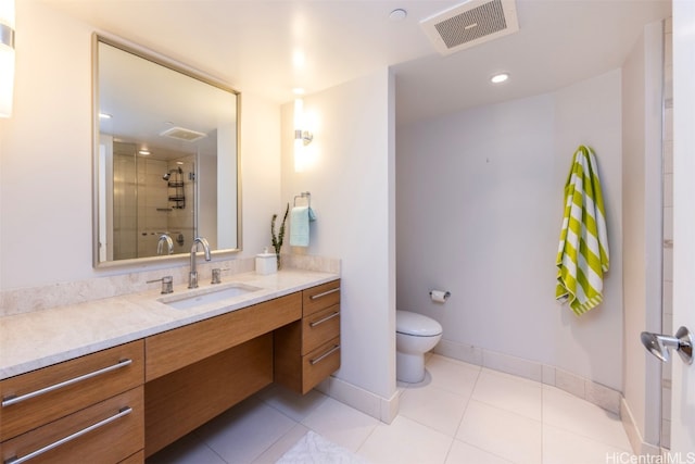 bathroom featuring vanity, a shower with shower door, toilet, and tile patterned floors