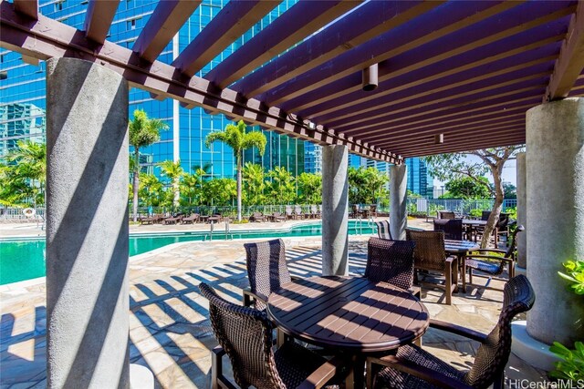 view of patio featuring a community pool and a pergola