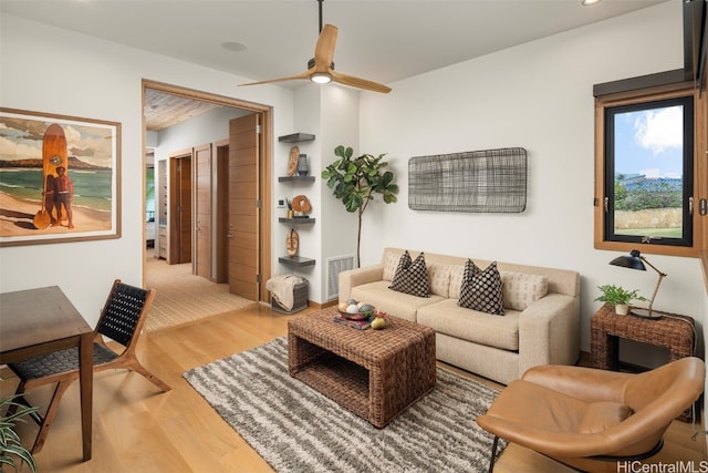 living room with hardwood / wood-style flooring and ceiling fan