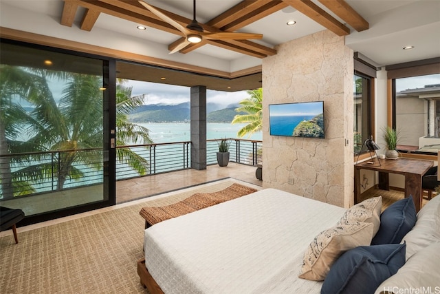 bedroom with ceiling fan, beam ceiling, and access to exterior