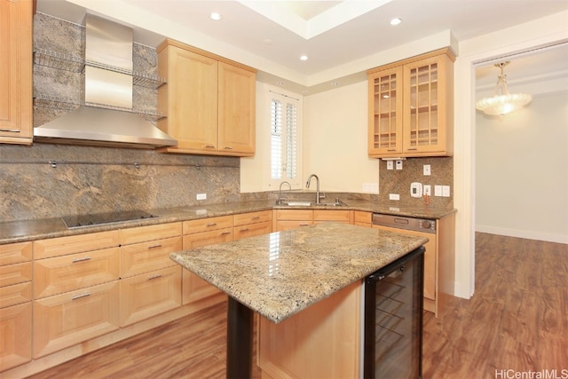 kitchen with black electric stovetop, wall chimney range hood, wine cooler, sink, and light hardwood / wood-style floors