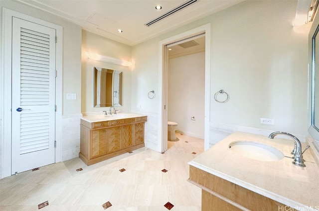 bathroom featuring vanity, toilet, and tile patterned floors