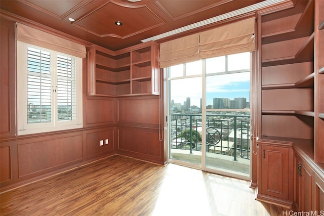 spare room with crown molding and light hardwood / wood-style flooring