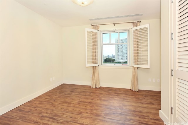 empty room with wood-type flooring