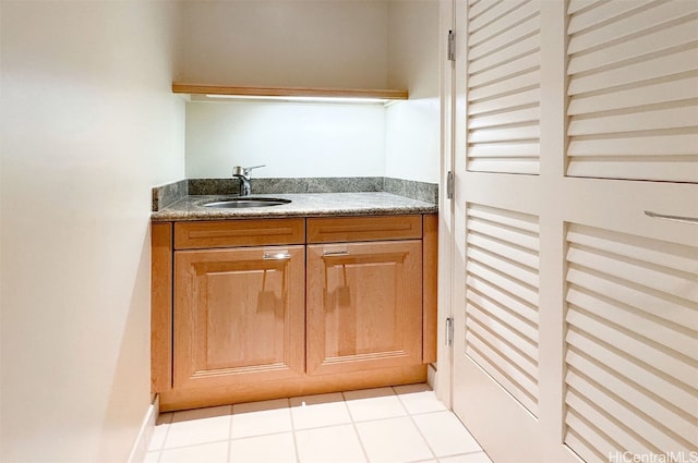 kitchen featuring sink and light tile patterned flooring