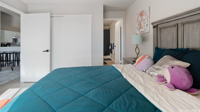 bedroom with a closet and light wood-type flooring