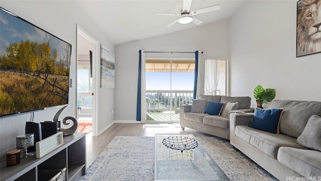 living room with lofted ceiling, light wood-type flooring, and ceiling fan