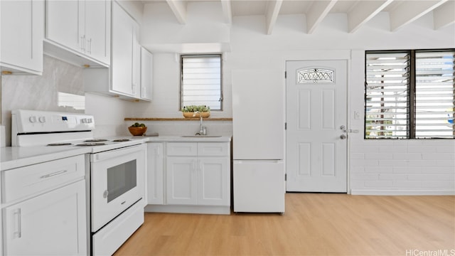 kitchen featuring white cabinets, sink, light wood-type flooring, and white appliances