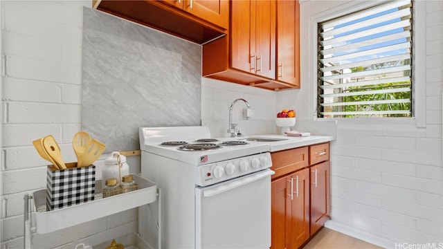 kitchen featuring white range and sink