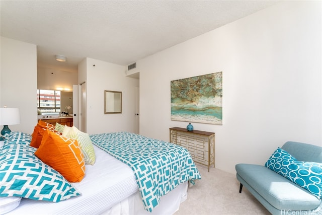 carpeted bedroom featuring a textured ceiling