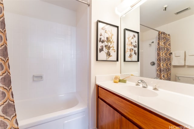 bathroom featuring vanity and shower / bath combination with curtain