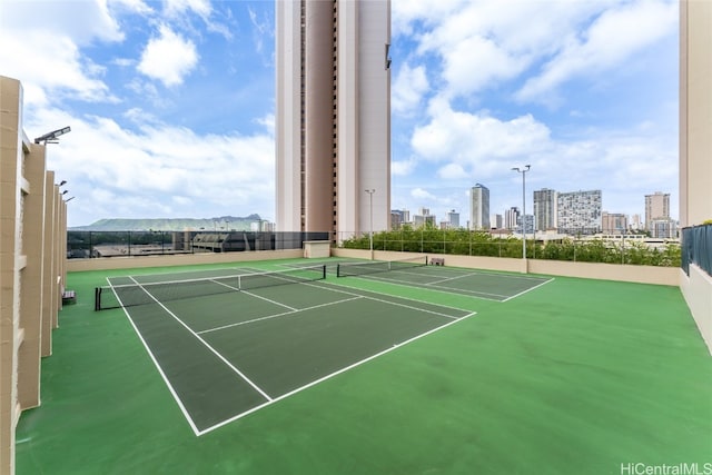 view of tennis court with a mountain view