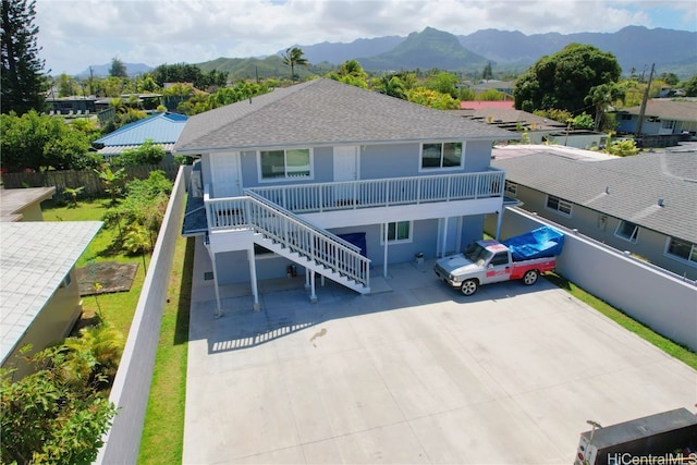 back of house with a mountain view and a balcony