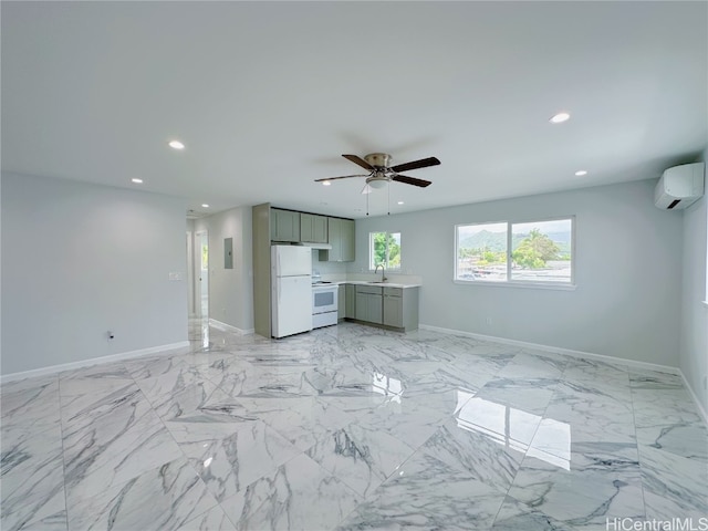 unfurnished living room with ceiling fan, electric panel, sink, and a wall unit AC