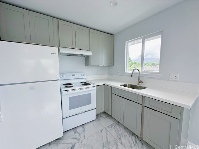 kitchen with white appliances, sink, and gray cabinetry