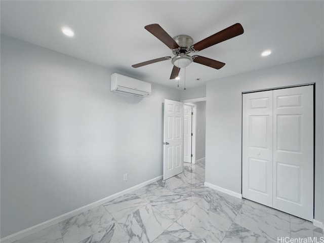 unfurnished bedroom with a wall unit AC, a closet, and ceiling fan