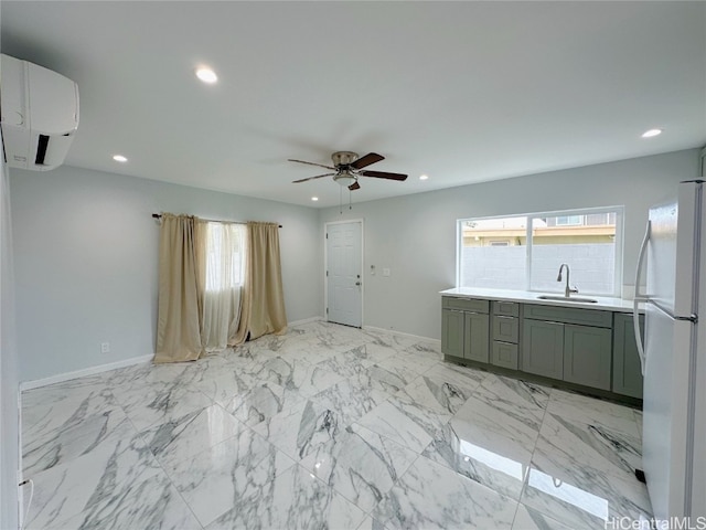 kitchen with white fridge, ceiling fan, an AC wall unit, and sink