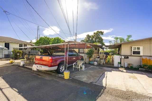 view of vehicle parking featuring a carport