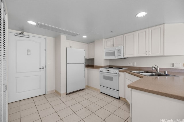 kitchen with sink, white cabinetry, white appliances, and light tile patterned floors