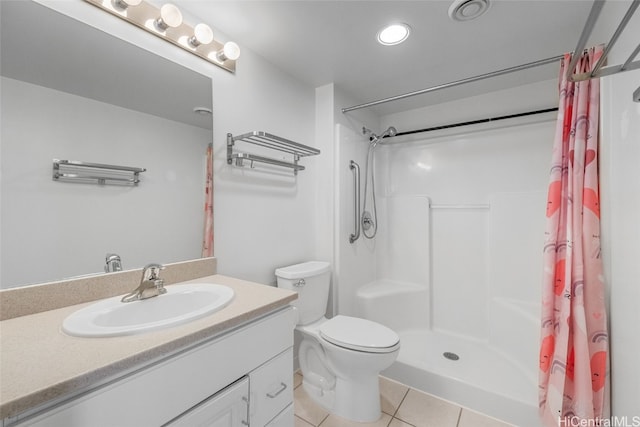 bathroom featuring vanity, toilet, walk in shower, and tile patterned flooring