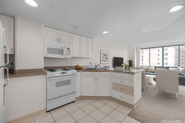 kitchen with kitchen peninsula, light tile patterned floors, white cabinetry, sink, and white appliances