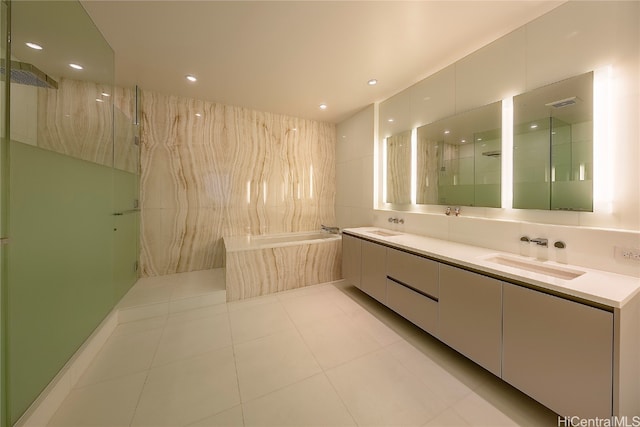 bathroom featuring vanity, shower with separate bathtub, and tile patterned floors