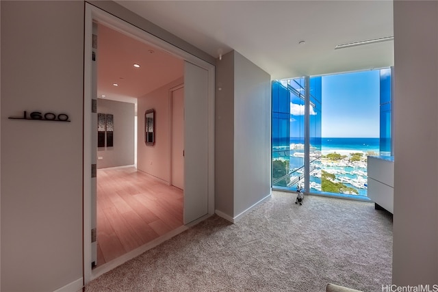 hallway with light hardwood / wood-style flooring