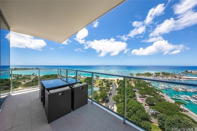 balcony featuring a water view and a beach view