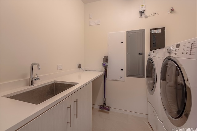 laundry room featuring washer and dryer, light tile patterned floors, sink, cabinets, and electric panel