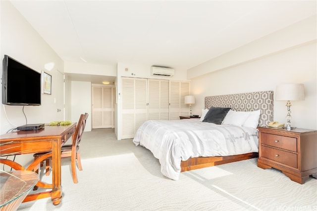 bedroom with light carpet, a closet, and a wall mounted AC