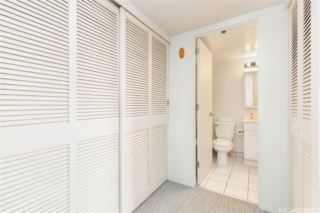 bathroom featuring vanity, toilet, and tile patterned flooring