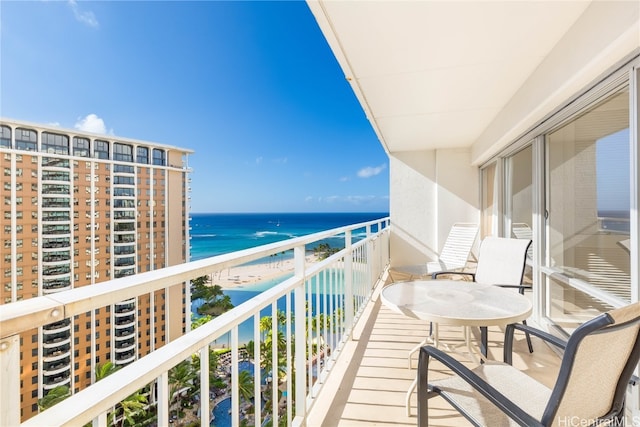 balcony featuring a water view and a view of the beach