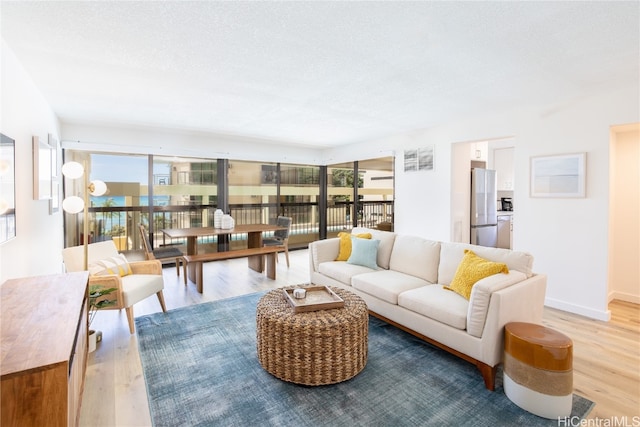 living room with hardwood / wood-style floors, a textured ceiling, and a wealth of natural light