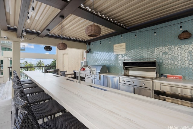 view of patio with area for grilling, ceiling fan, sink, and a grill