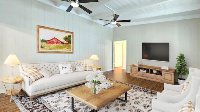 living room with beam ceiling, wooden walls, wood-type flooring, and ceiling fan