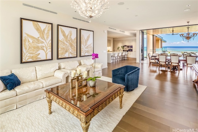 living room featuring wood-type flooring and a chandelier