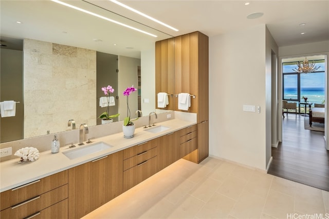 bathroom with vanity, a notable chandelier, and hardwood / wood-style floors