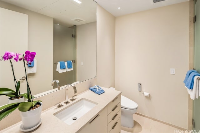 bathroom featuring toilet, an enclosed shower, vanity, and tile patterned flooring