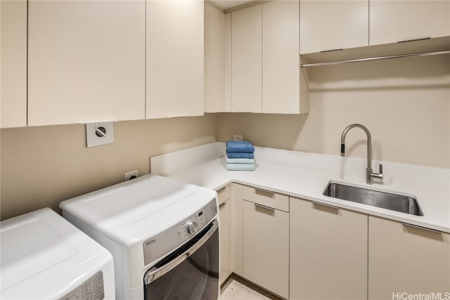 washroom featuring sink, cabinets, and separate washer and dryer