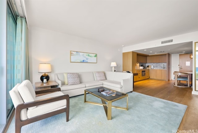 living room with light hardwood / wood-style flooring