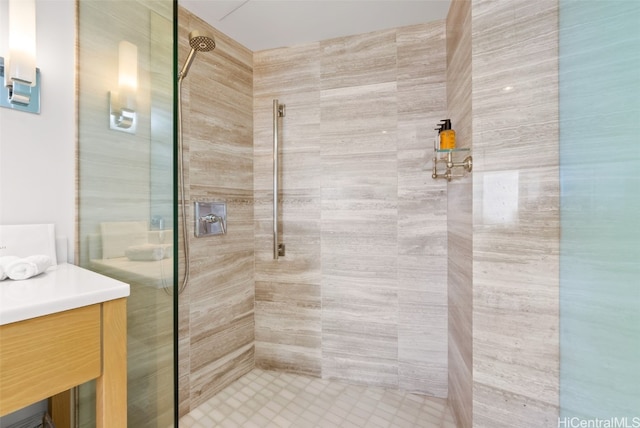 bathroom featuring vanity and tiled shower