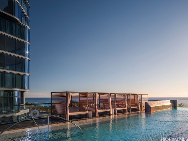 pool at dusk with a water view