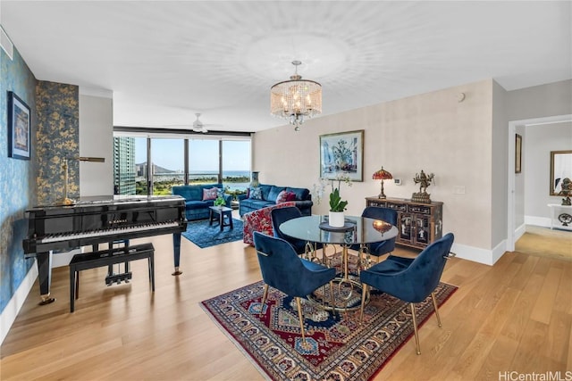 dining area featuring an inviting chandelier and light hardwood / wood-style floors