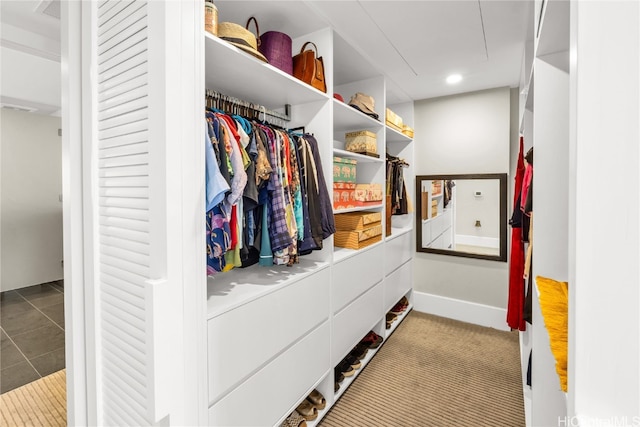 spacious closet featuring light carpet