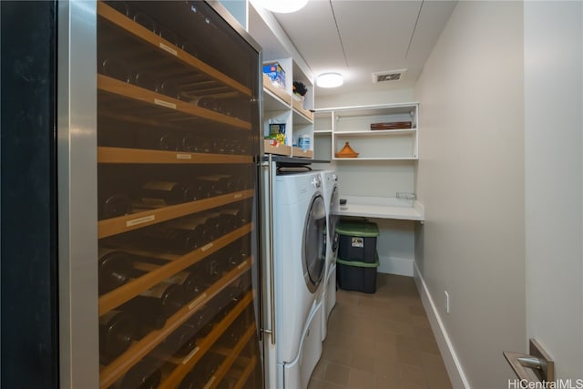 laundry room featuring wine cooler and independent washer and dryer